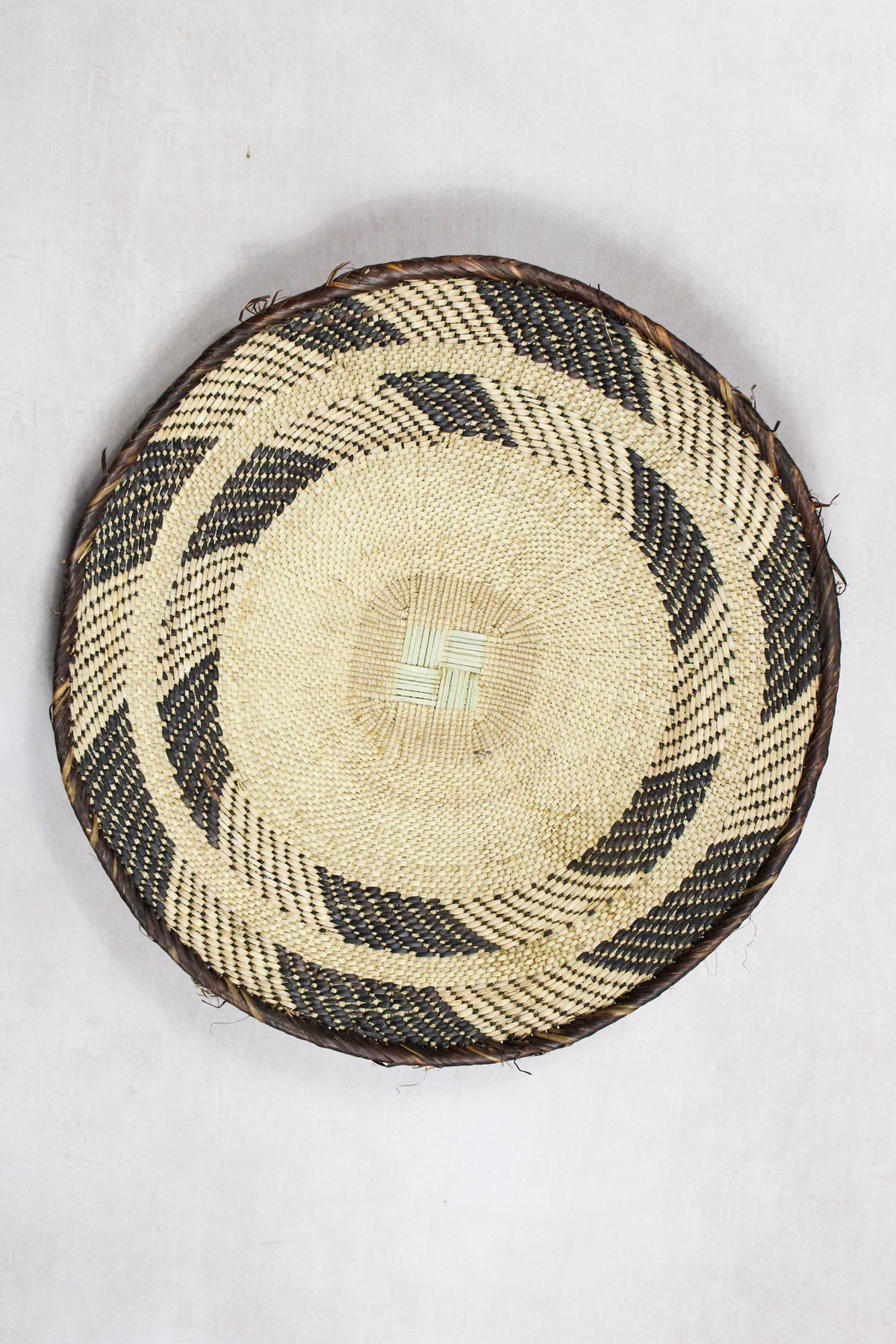 Handwoven Tonga wall basket from set No. 90 with contrasting natural woven pattern
