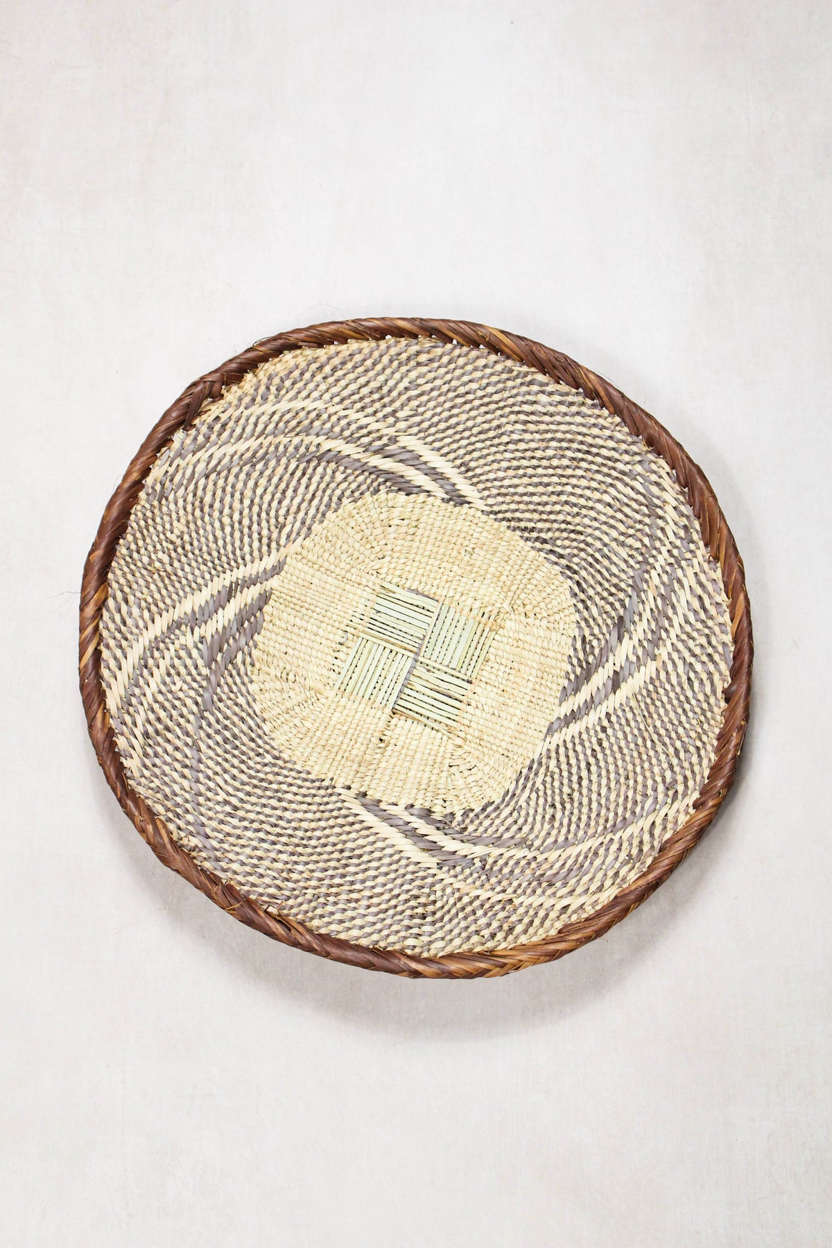 Handwoven Tonga wall basket from set No. 90 showing naturally dyed woven detailing