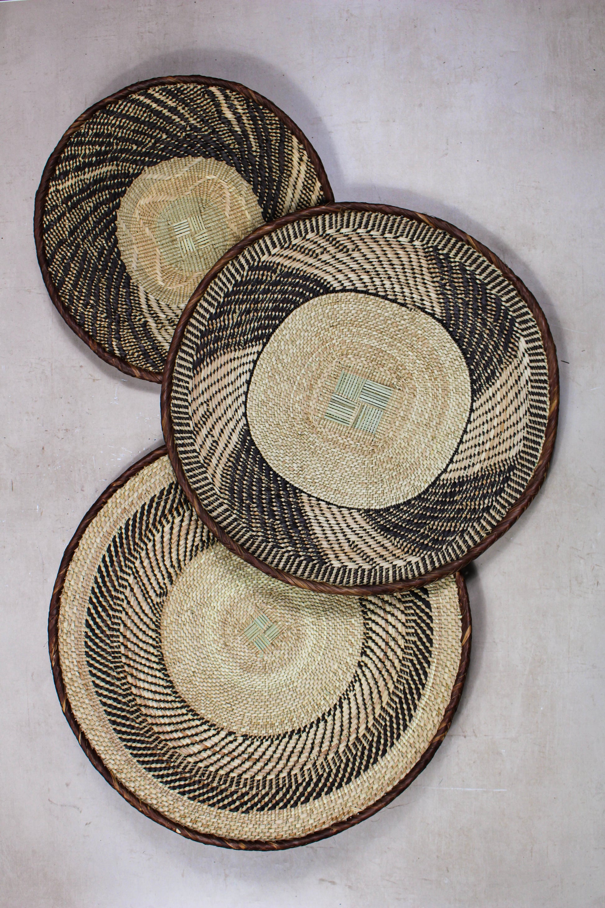 Set of three handwoven Tonga wall baskets No. 23 in natural earthy tones with traditional woven patterns