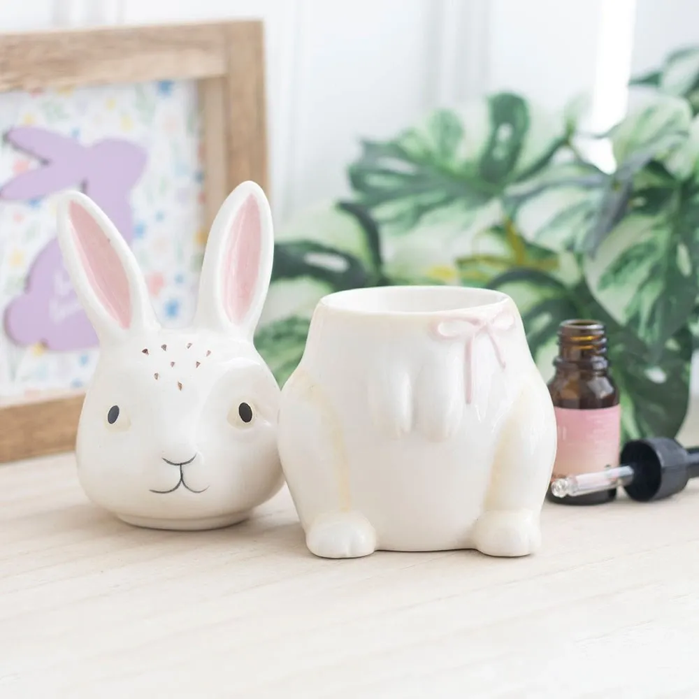 Bunny shaped ceramic oil burner styled in a bright home setting with decorative accessories.