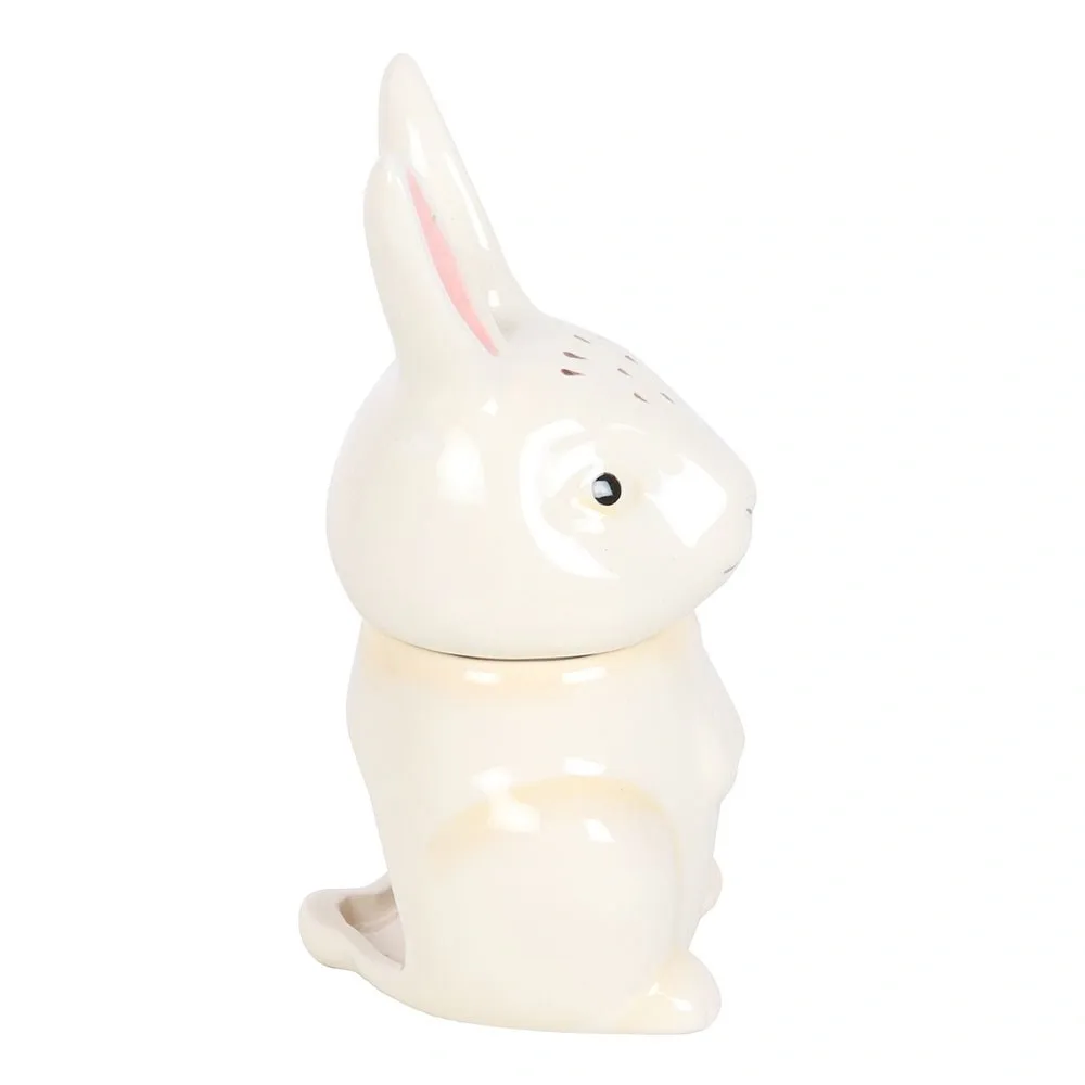Side profile of the bunny shaped ceramic oil burner showing its decorative rabbit design.