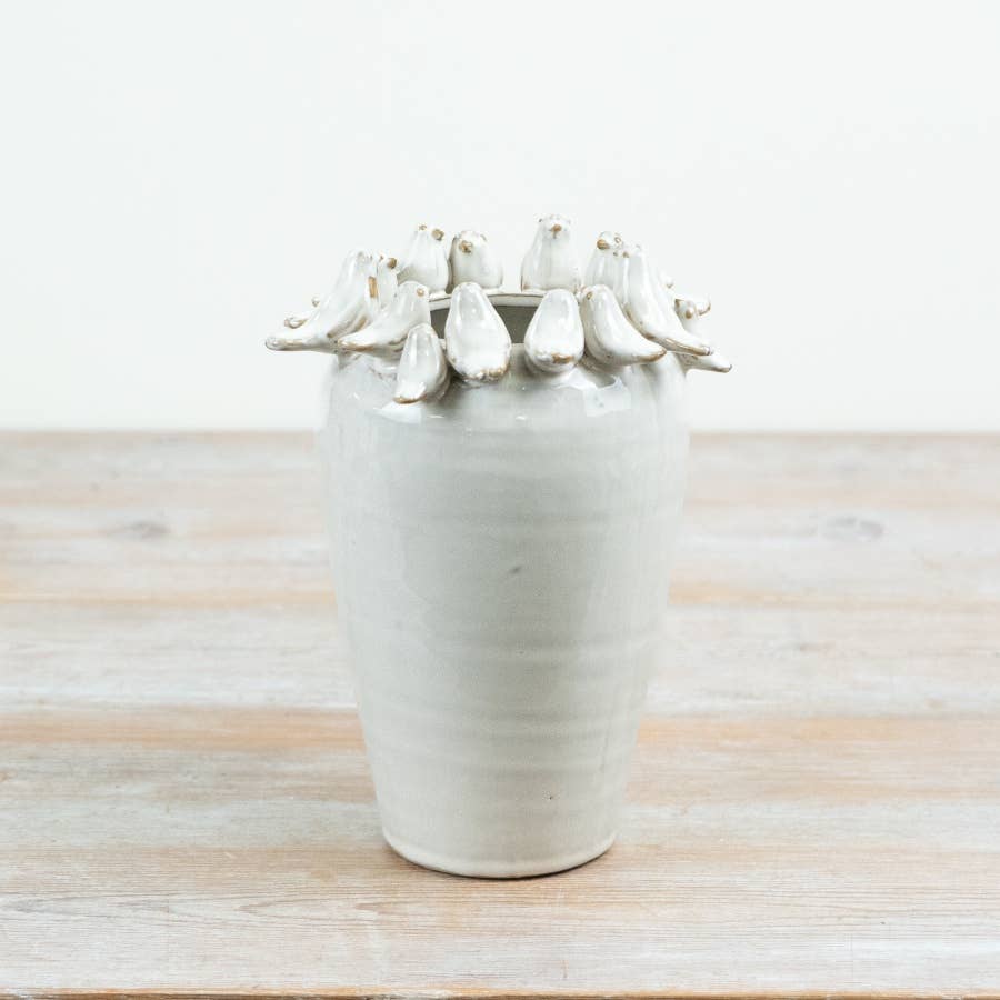 White ceramic bird vase with sculpted birds around the rim, 22cm