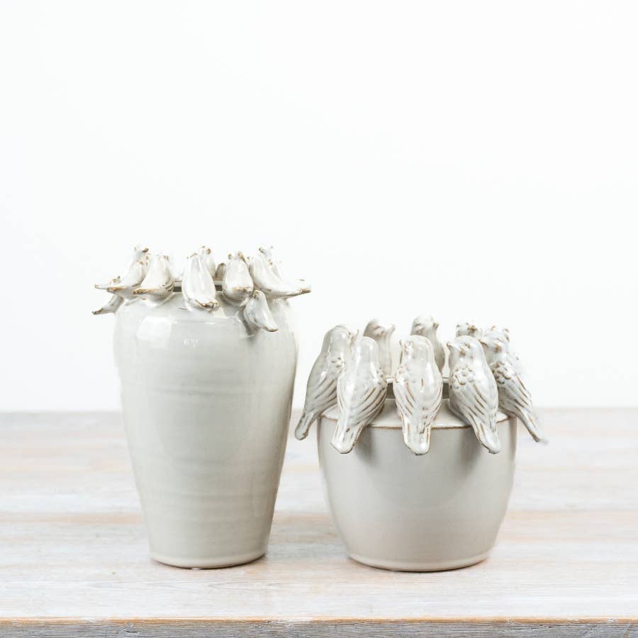 White ceramic bird vase displayed with coordinating bird planter