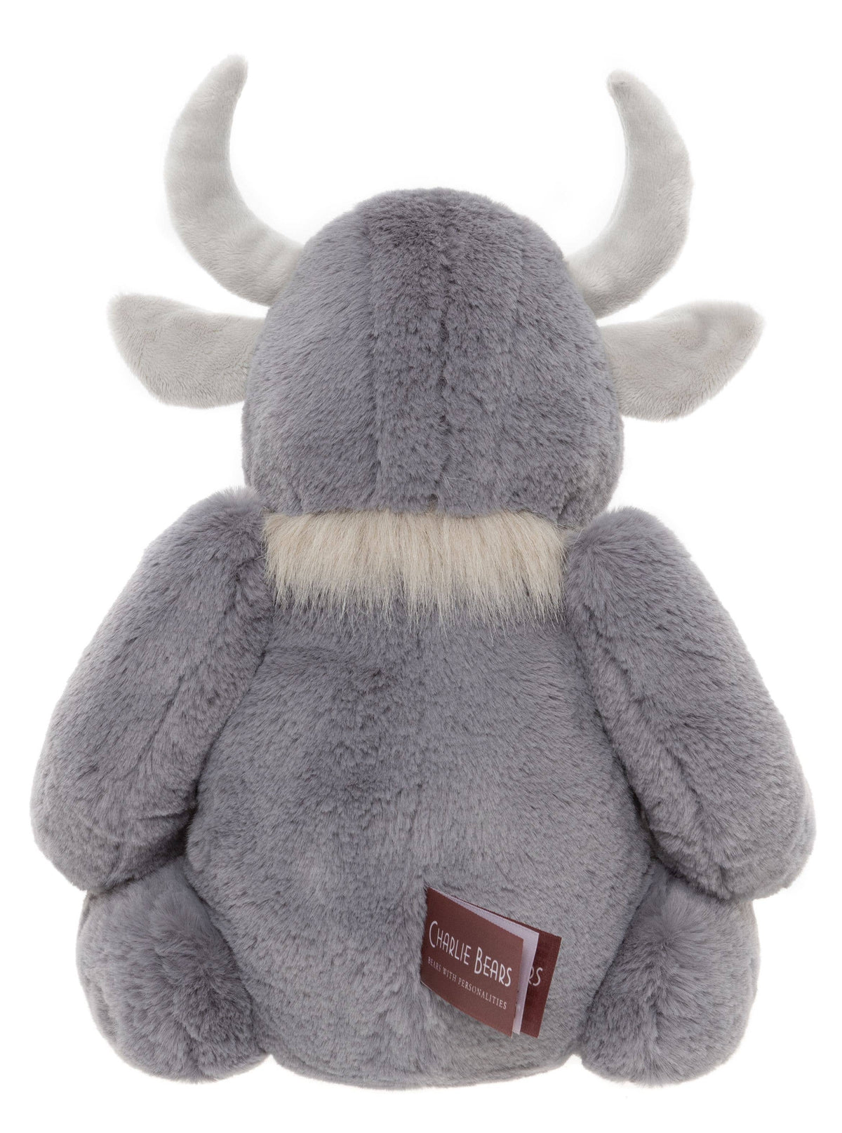 Charlie Bears Cobblestone rear view showing his soft grey plush body, curved horns and small fabric label