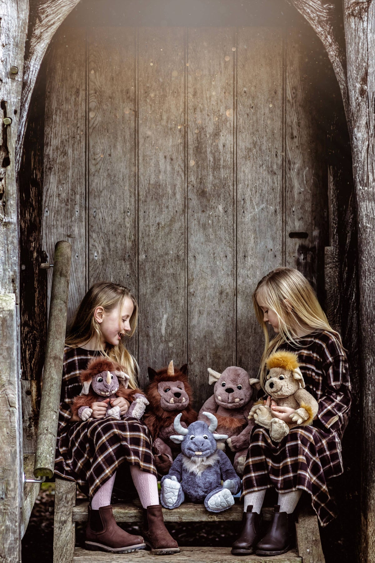 Charlie Bears Cobblestone pictured with other Bearhouse mythical plush characters and children outdoors