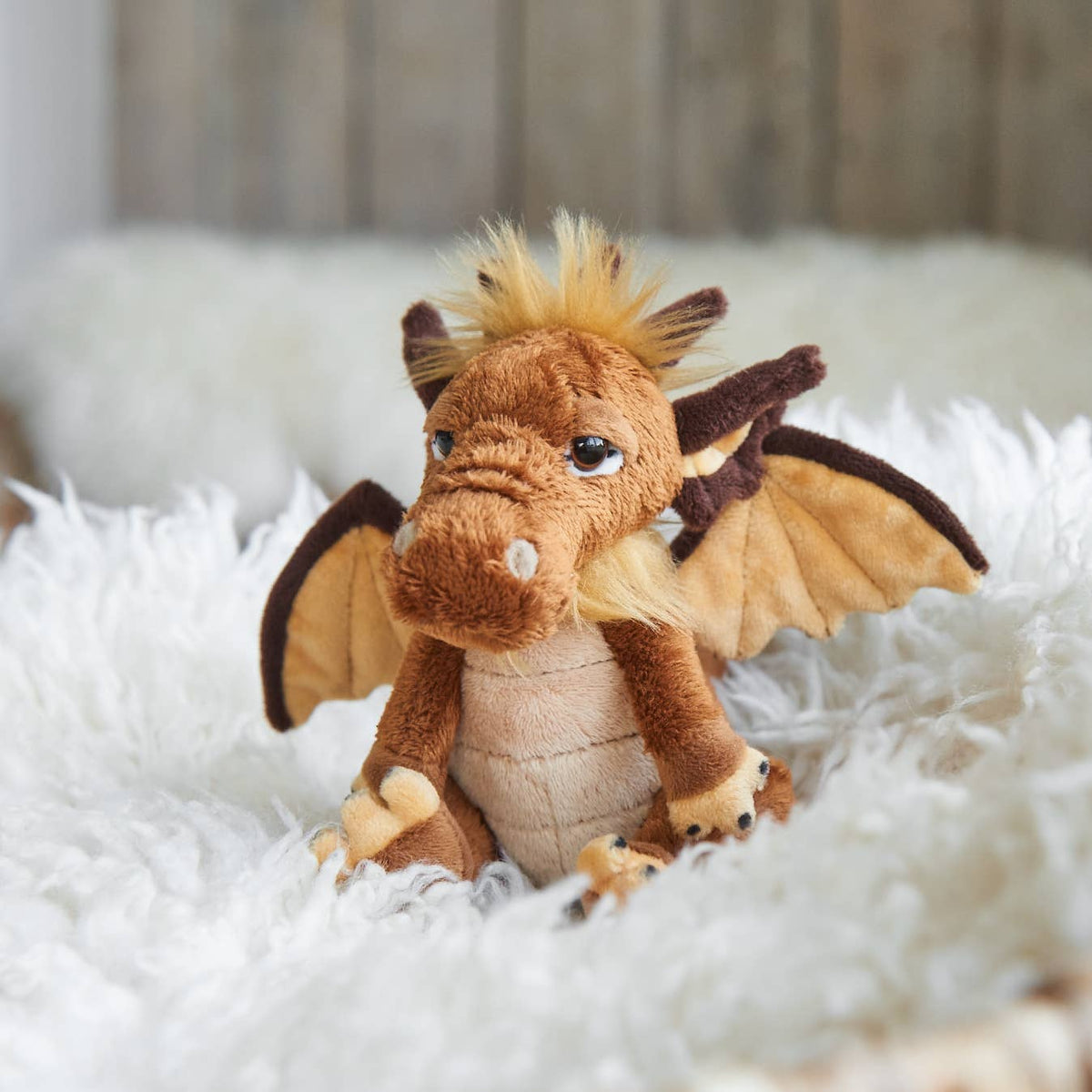 Charlie Bears Cuddle Cub Lantern pocket-sized plush dragon in a home setting