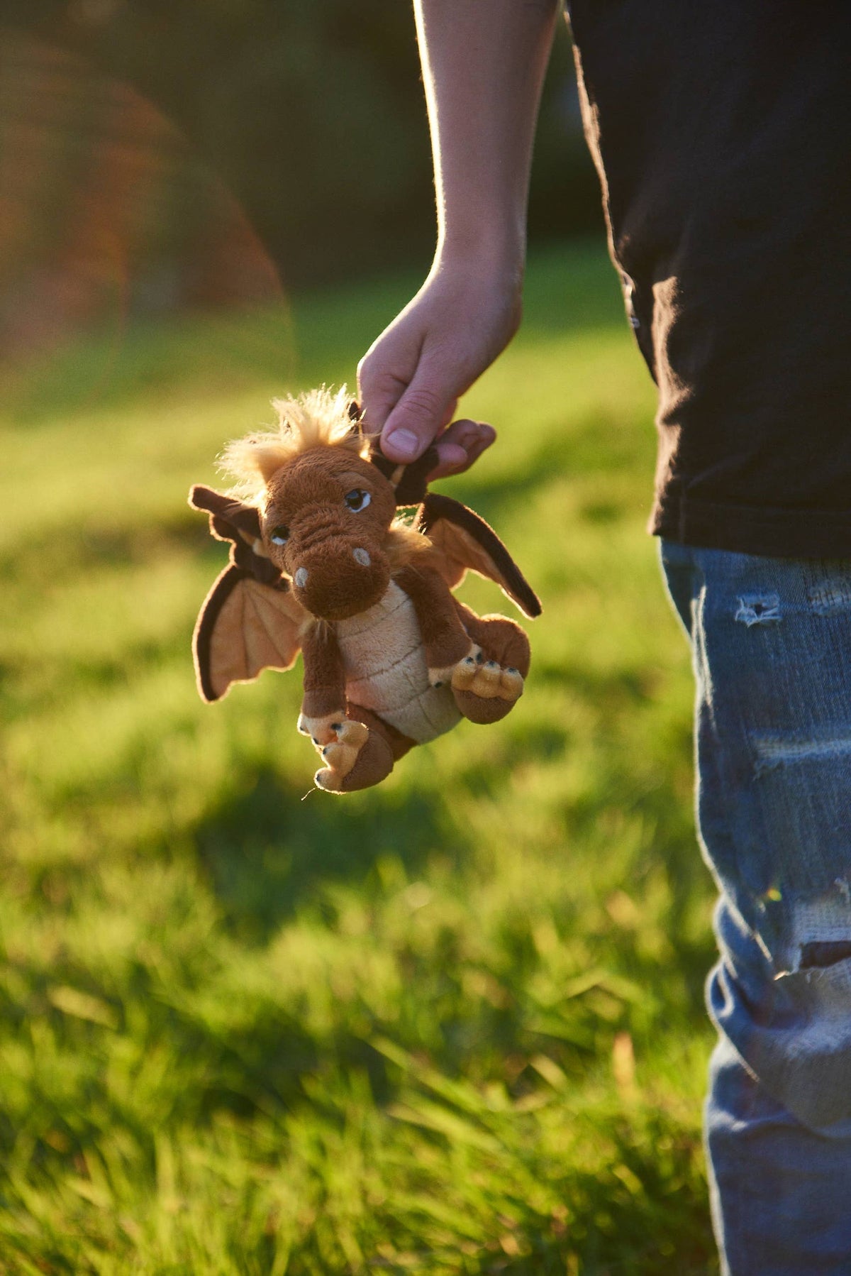 Charlie Bears Cuddle Cub Lantern pocket-sized plush dragon held in a hand
