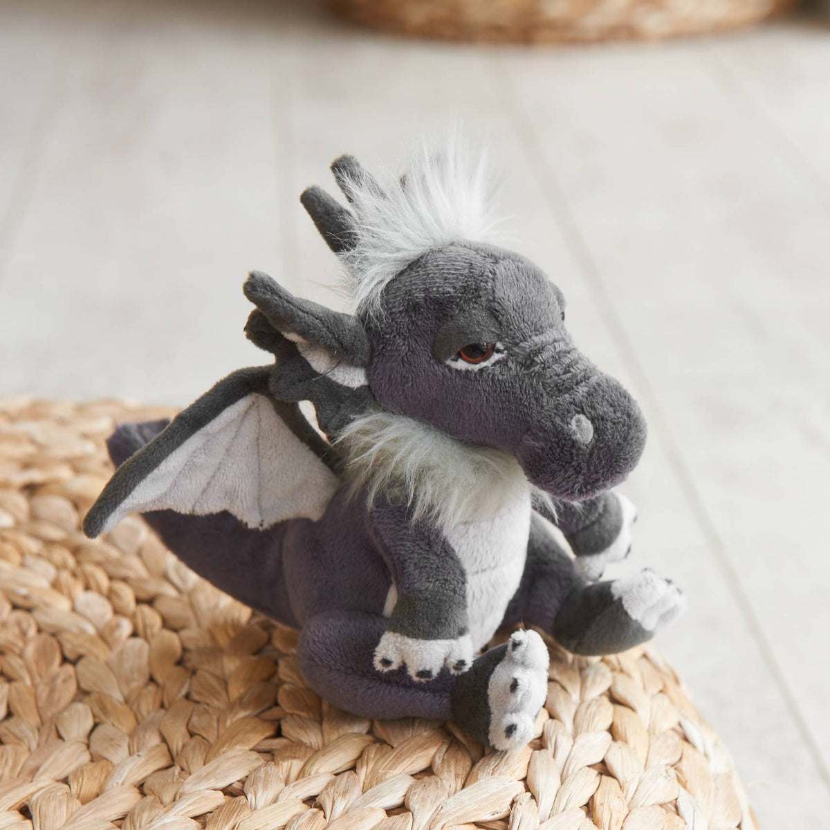 Charlie Bears Cuddle Cub Soot pocket-sized grey plush dragon outdoors