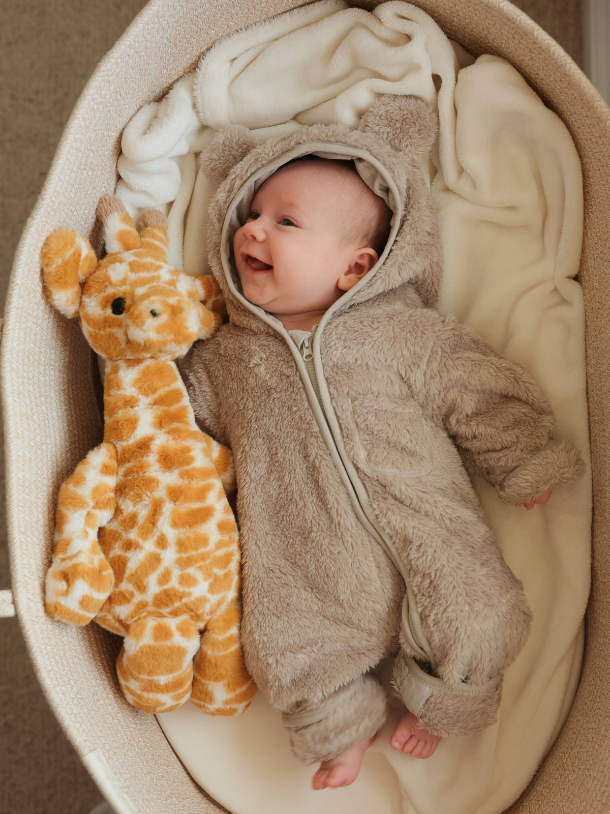 Charlie Bears Gilbert Giraffe plush soft toy being cuddled