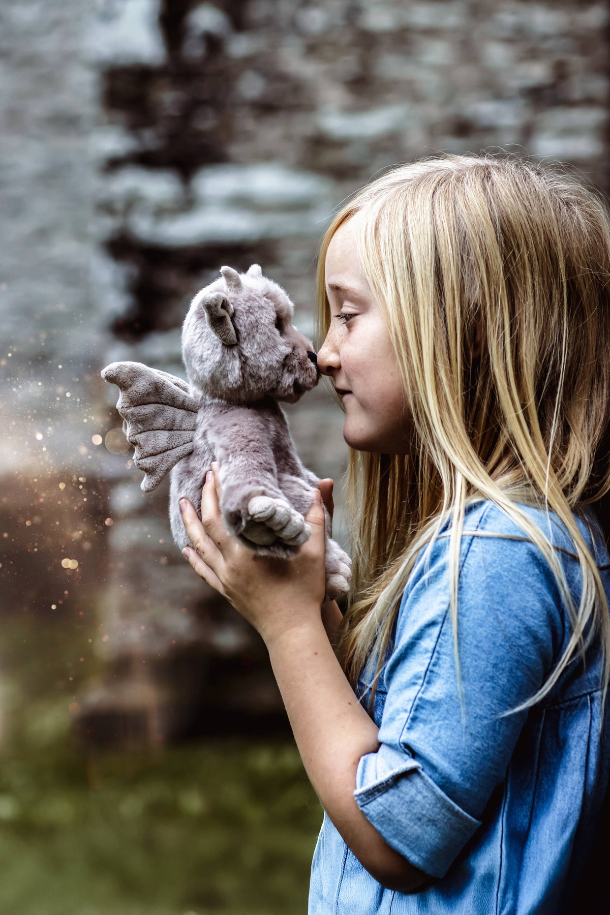 Charlie Bears Moat soft grey gargoyle being held by a child outdoors