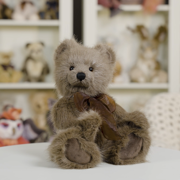 Charlie Bears Oak brown plush teddy bear displayed in a softly styled home setting