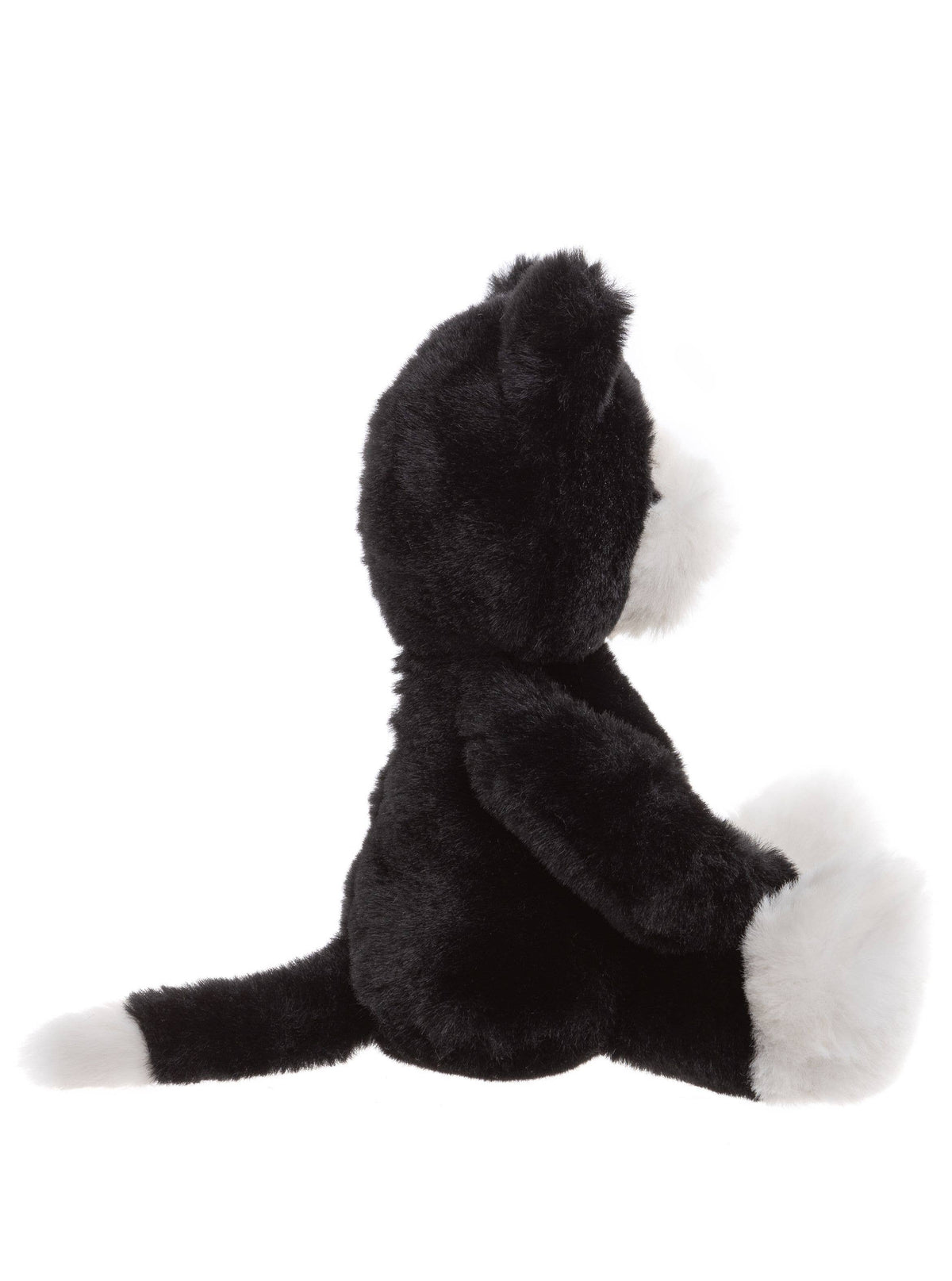 Side view of Charlie Bears Pudgy Kitten black and white plush cat