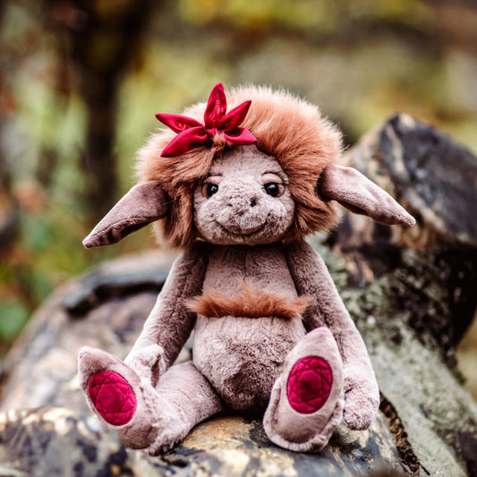Charlie Bears Ruby Roo from the Bearhouse collection with fluffy mane and embroidered ruby gemstone paw pads