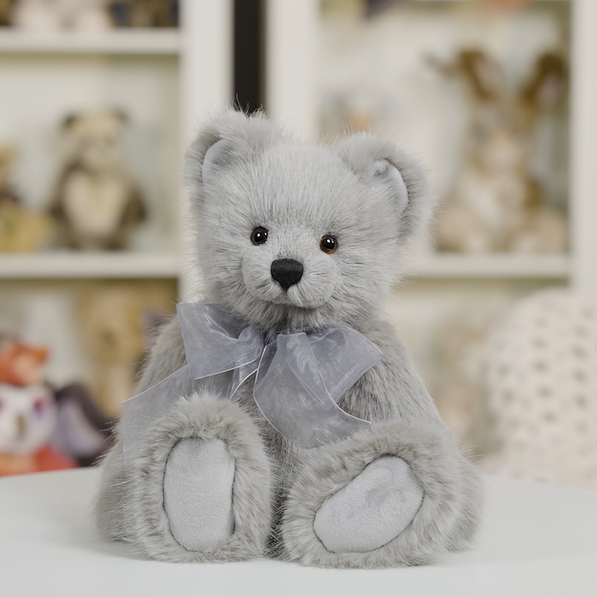Charlie Bears Silver Birch pale grey plush teddy bear displayed in a softly styled home setting