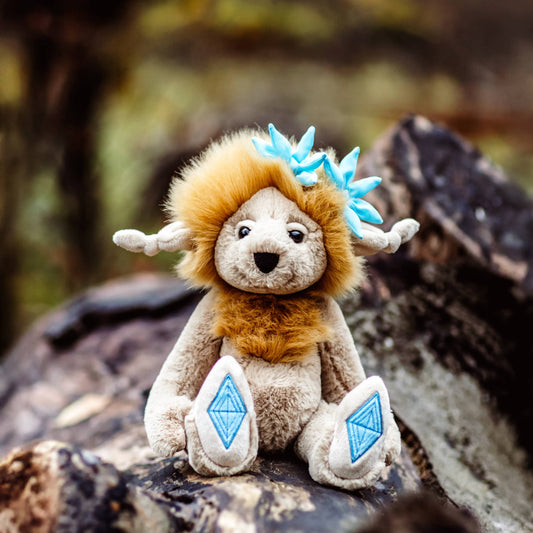 Charlie Bears Topaz Blu from the Bearhouse collection with fluffy golden mane and embroidered topaz gemstone paw pads