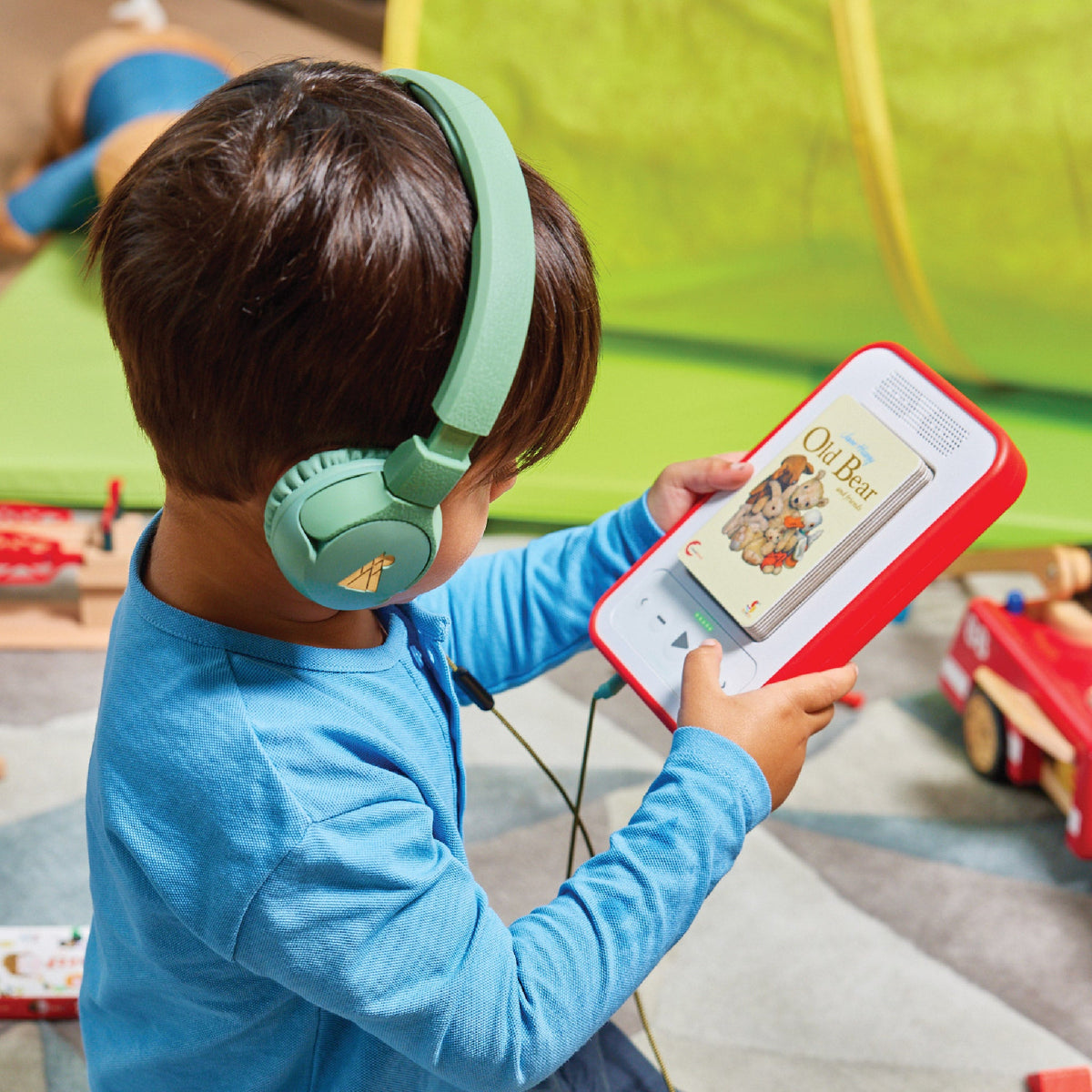 Child enjoying a Voxblock audiobook player with headphones