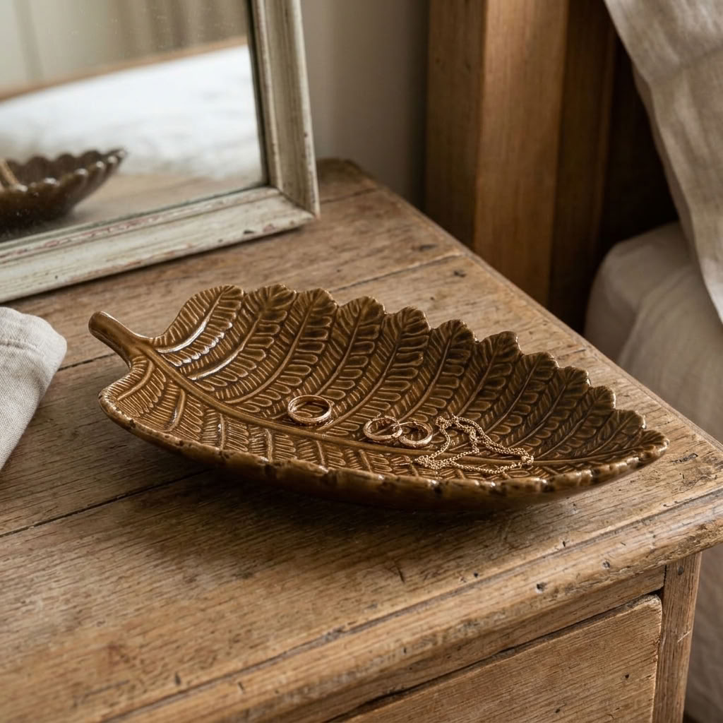Decorative Leaf Trinket Dish with jewellery styled on an aged wooden dressing table in a country bedroom