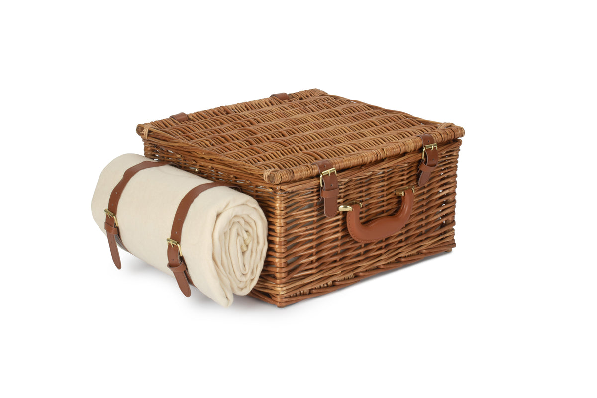Closed Deluxe 2 Person Willow Picnic Hamper with cream picnic rug secured to the side