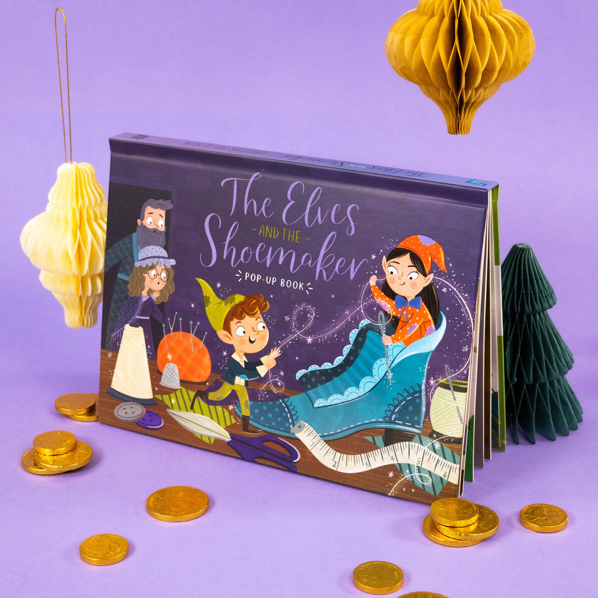 The Elves and the Shoemaker pop-up book displayed against a purple background with festive decorative details