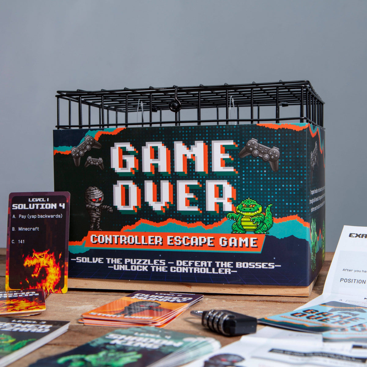 Game Over Controller Escape Room Game with metal controller cage, puzzle cards and combination padlock