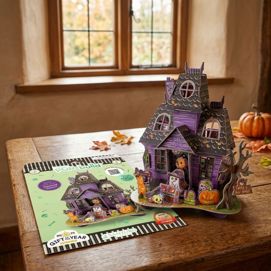 Halloween House Pop and Build displayed on a rustic wooden table with its packaging in an autumn country home
