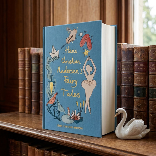 Hans Christian Andersen's Fairy Tales Wordsworth hardback on an aged oak library shelf with a white swan ornament