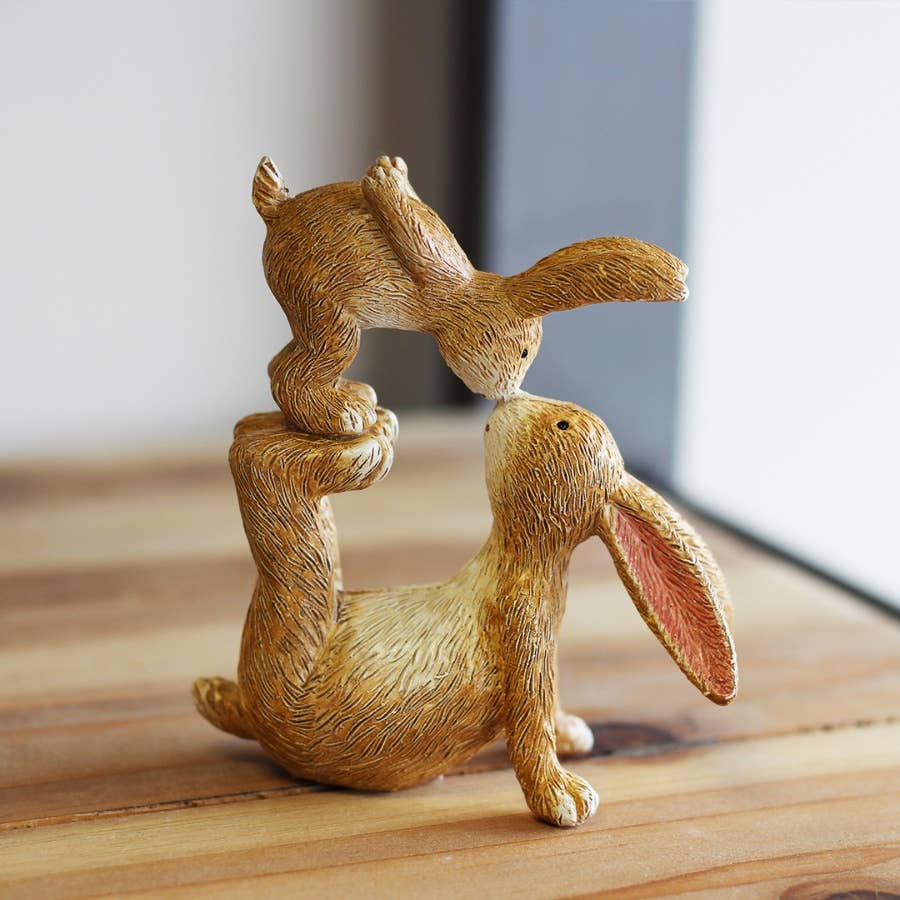 Kissing Bunnies rabbit ornament styled beside a bright country house window