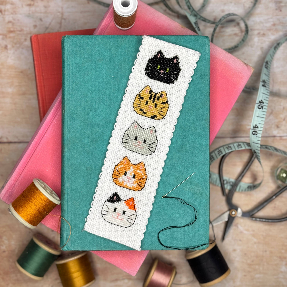 Kitty Cats Cross Stitch Bookmark Kit finished cat bookmark styled with colourful books and sewing threads