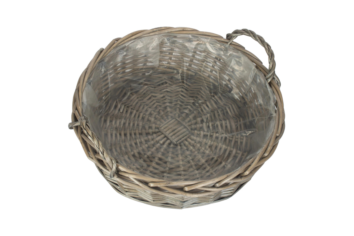 Large round antique wash willow display basket viewed from above showing its clear plastic lining and woven base