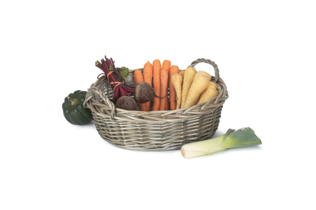 Large round antique wash willow display basket filled with carrots, parsnips and beetroot, with woven handles