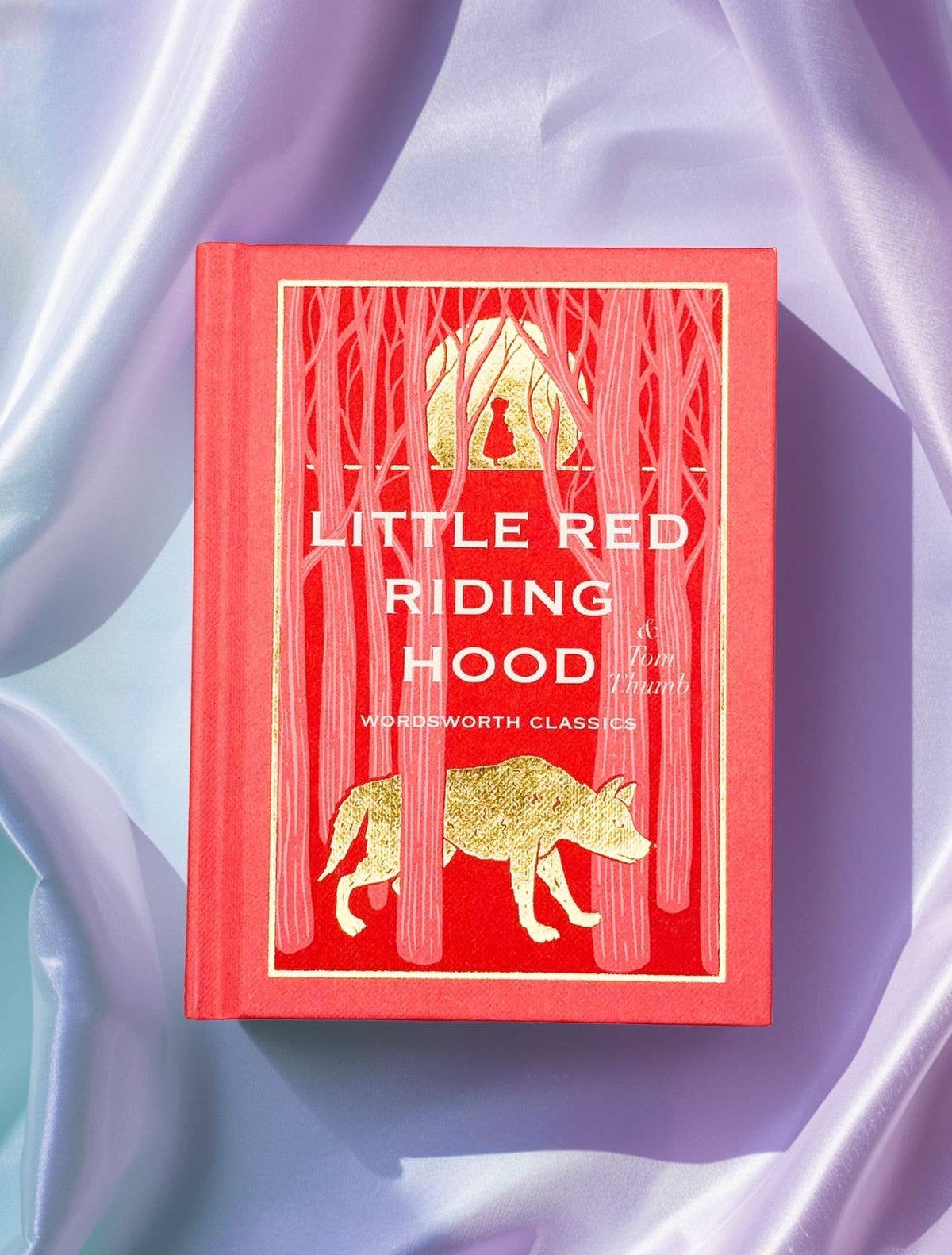 Little Red Riding Hood Wordsworth Pocket Fairytales red hardback with gold foil illustrated cover displayed on lavender satin fabric