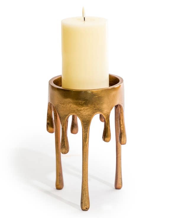 Medium Gold Dali Drip Candle Holder with sculptural melting-wax design and cream pillar candle against a white background
