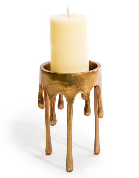 Medium Gold Dali Drip Candle Holder with sculptural melting-wax design and cream pillar candle against a white background