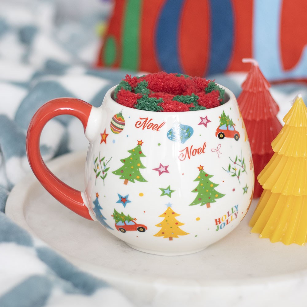 Nostalgic Christmas Mug and Socks Gift Set with colourful festive illustrations, red handle and striped socks in a Christmas setting
