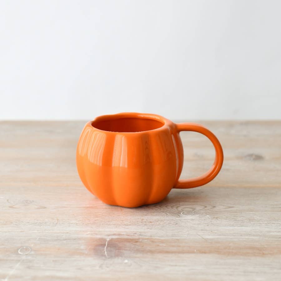 Orange ceramic pumpkin-shaped mug with glossy finish