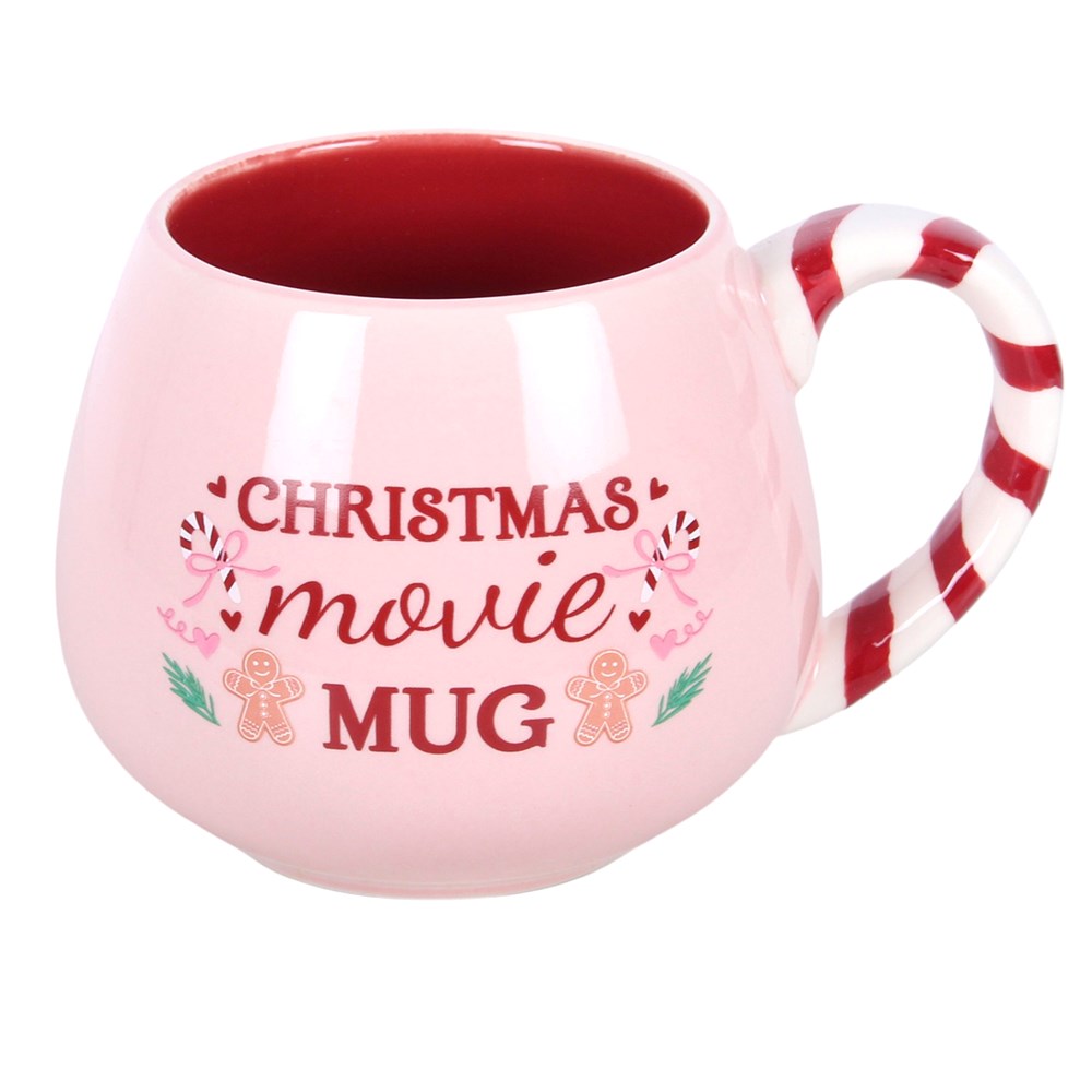 Pink Christmas Movie Mug with Christmas lettering, gingerbread illustrations and red and white candy cane handle