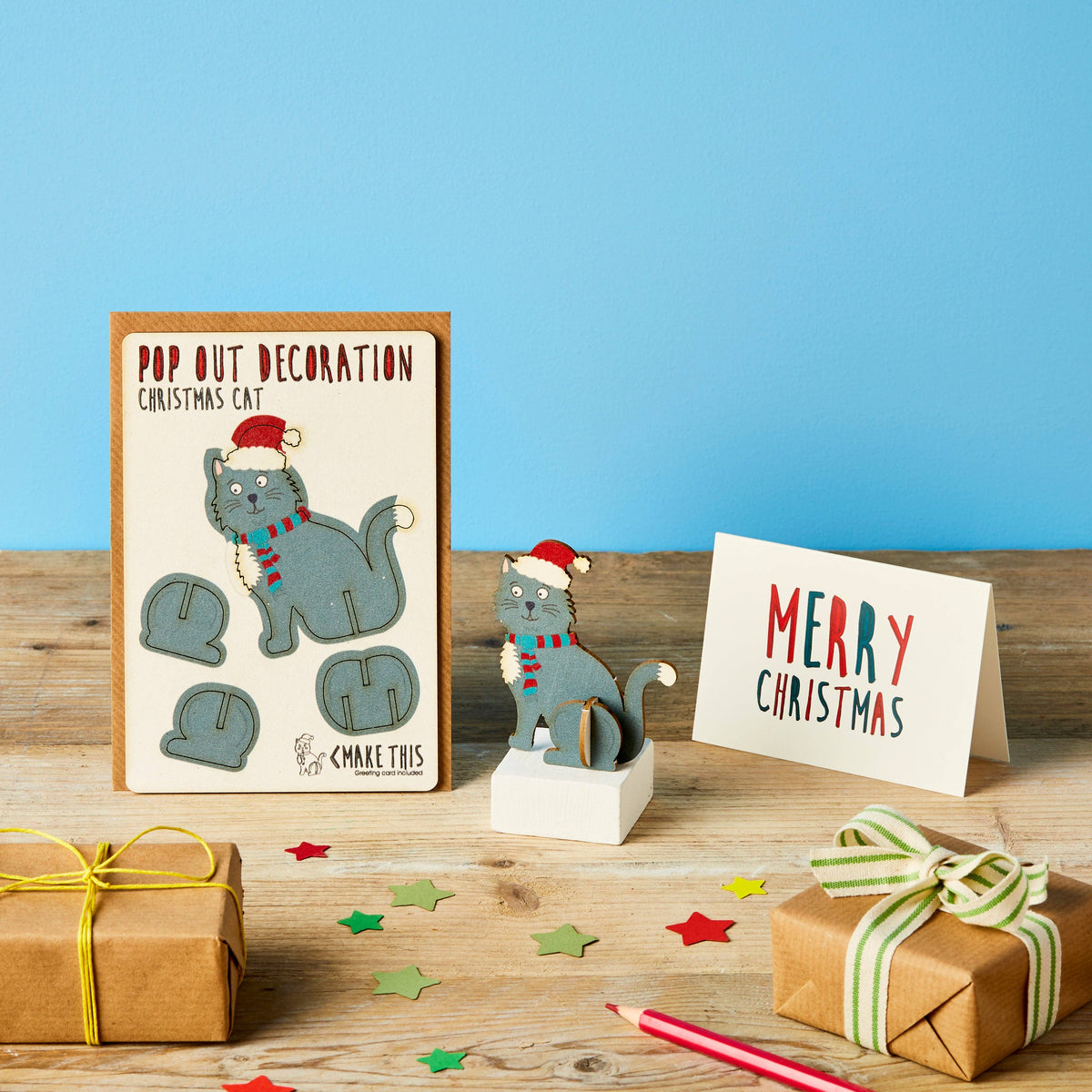 Pop Out Cat Christmas Card with assembled festive grey cat decoration styled with Christmas gifts and decorations