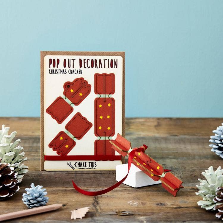 Pop Out Cracker Christmas Card with assembled red Christmas cracker and ribbon displayed in a festive Christmas setting