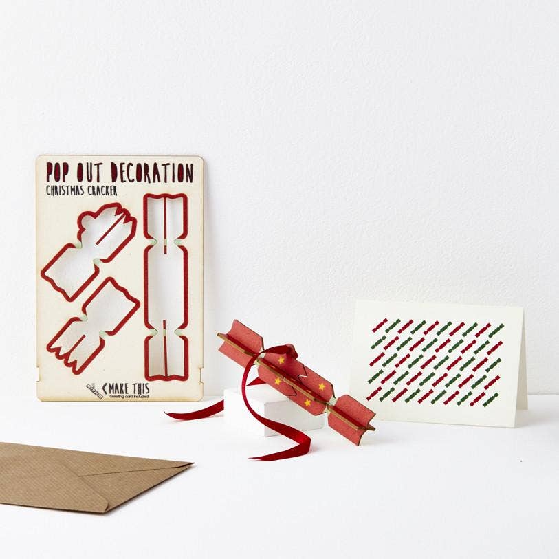 Pop Out Cracker Christmas Card showing the pop-out cracker decoration, patterned greeting card, red hanging ribbon and brown envelope