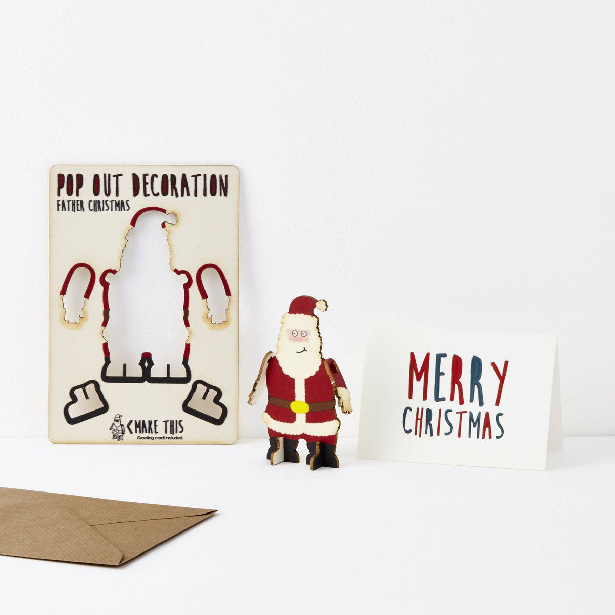 Pop Out Father Christmas Card showing the flat pop-out design, assembled wooden decoration and Merry Christmas message card