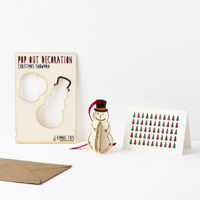 Pop Out Hanging Snowman Christmas Card showing the pop-out sheet, assembled wooden snowman, red ribbon and patterned greeting card