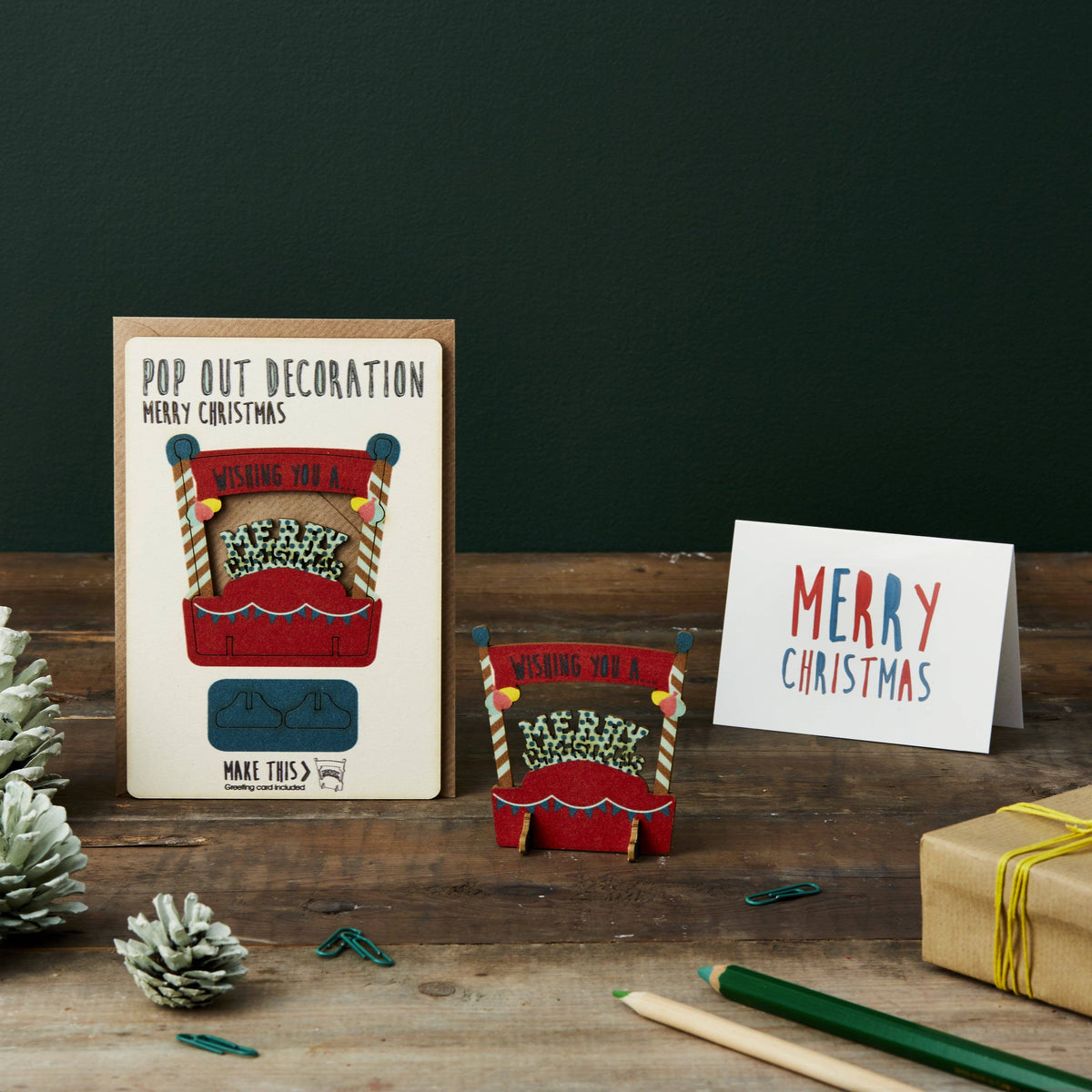 Pop Out Merry Christmas Card with assembled wooden Merry Christmas decoration styled in a festive setting