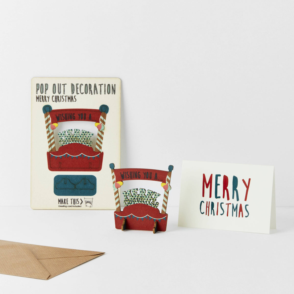 Pop Out Merry Christmas Card showing the pop-out sheet, assembled wooden decoration, greeting card and brown envelope