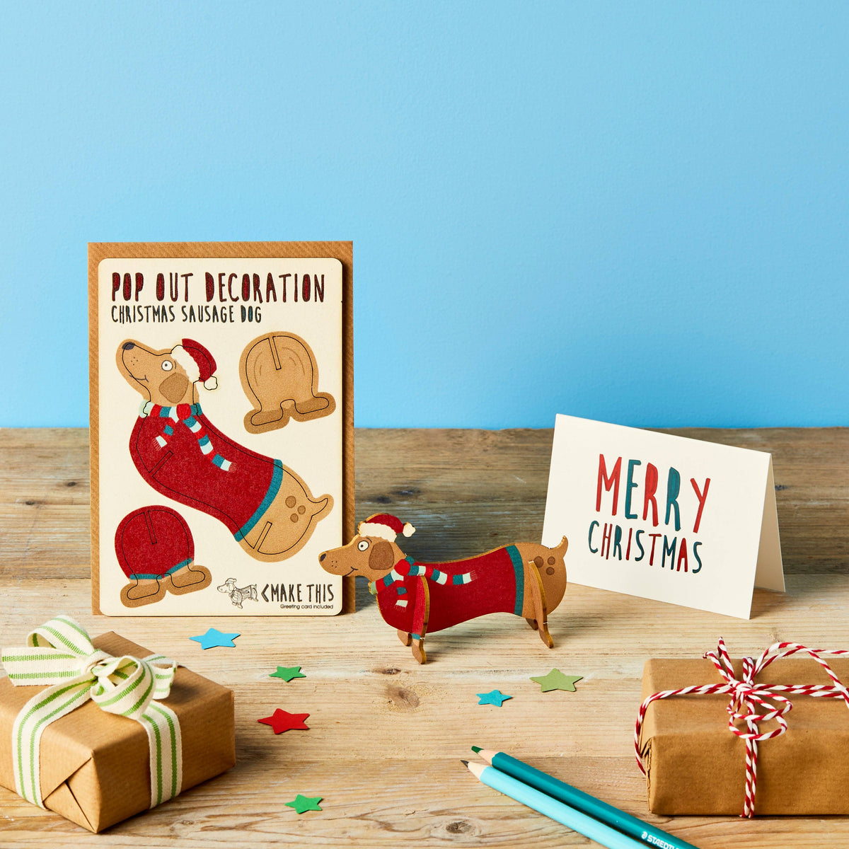 Pop Out Sausage Dog Christmas Card with assembled wooden festive dachshund, Merry Christmas card and wrapped gifts