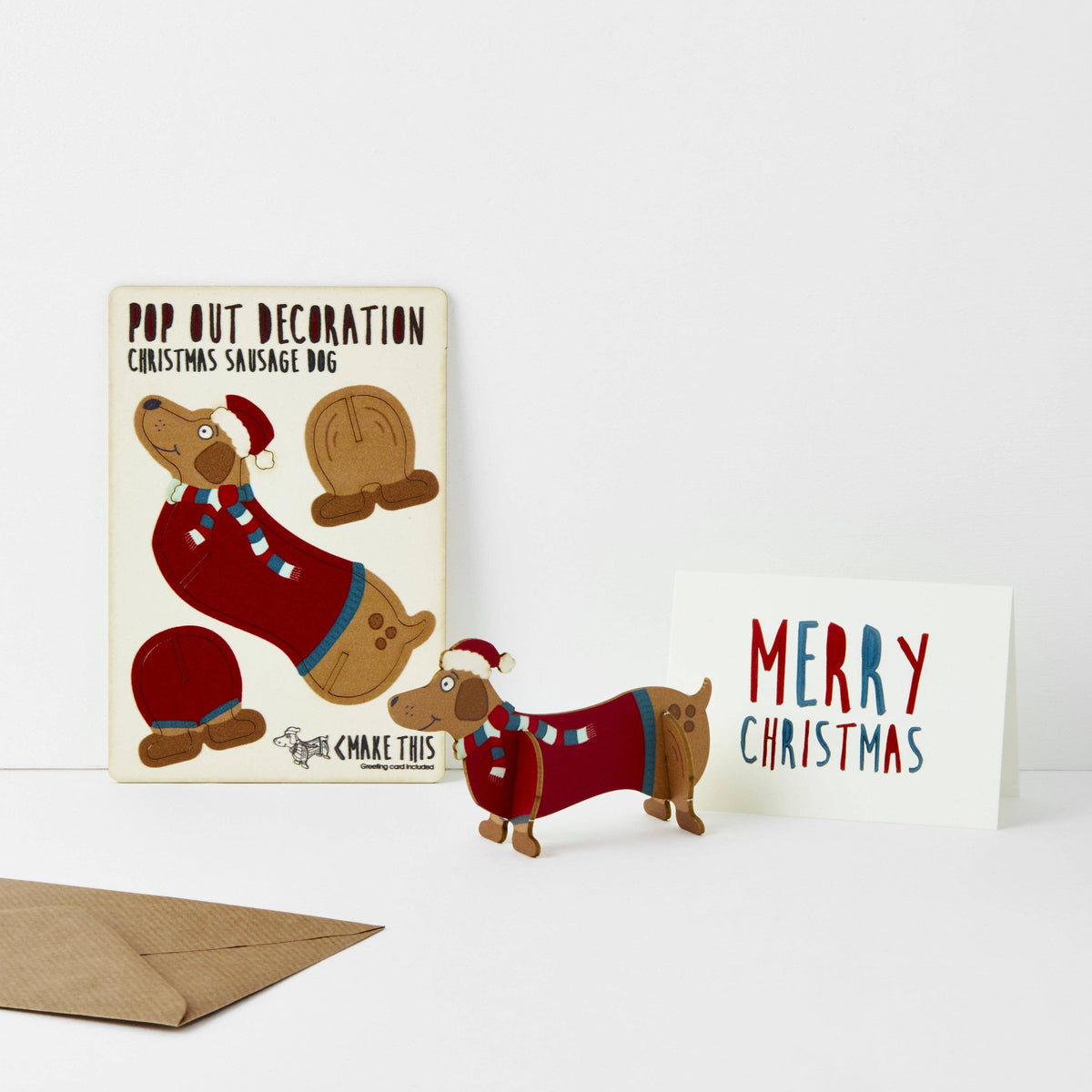 Pop Out Sausage Dog Christmas Card showing the pop-out sheet, assembled wooden dachshund and Merry Christmas card