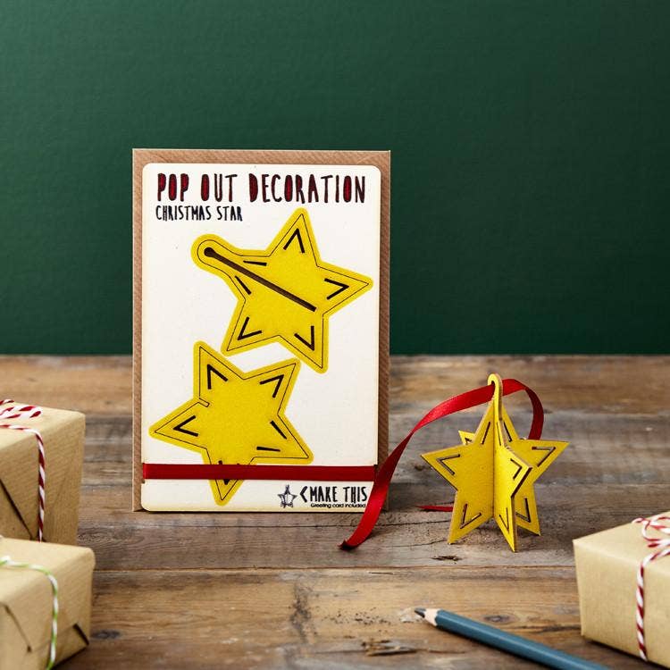 Pop Out Star Christmas Card with assembled yellow wooden star decoration, red hanging ribbon and festive gift styling
