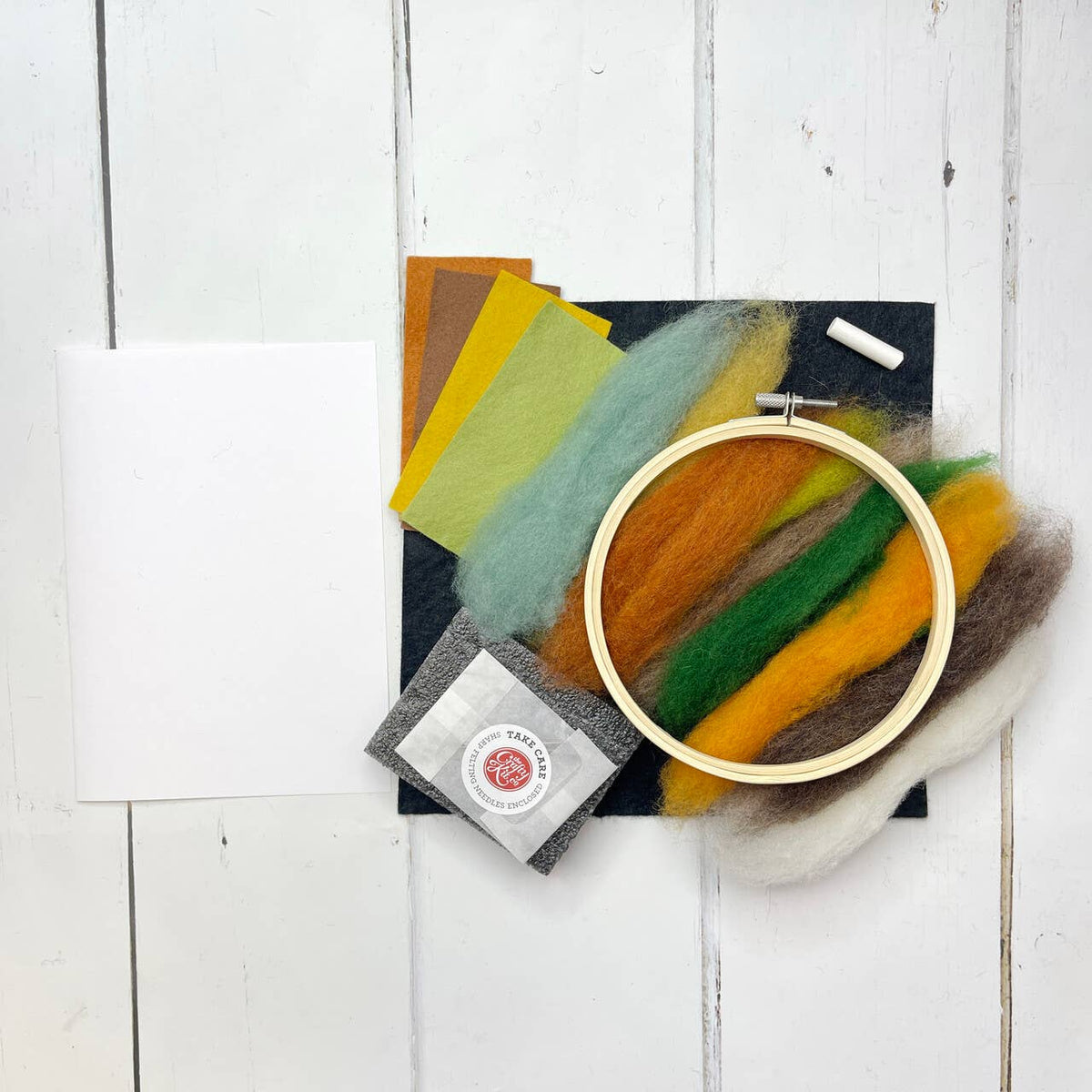 Paint with Wool Pumpkin Needle Felting Kit materials including bamboo hoop, felting wool, needles, felt and foam mat