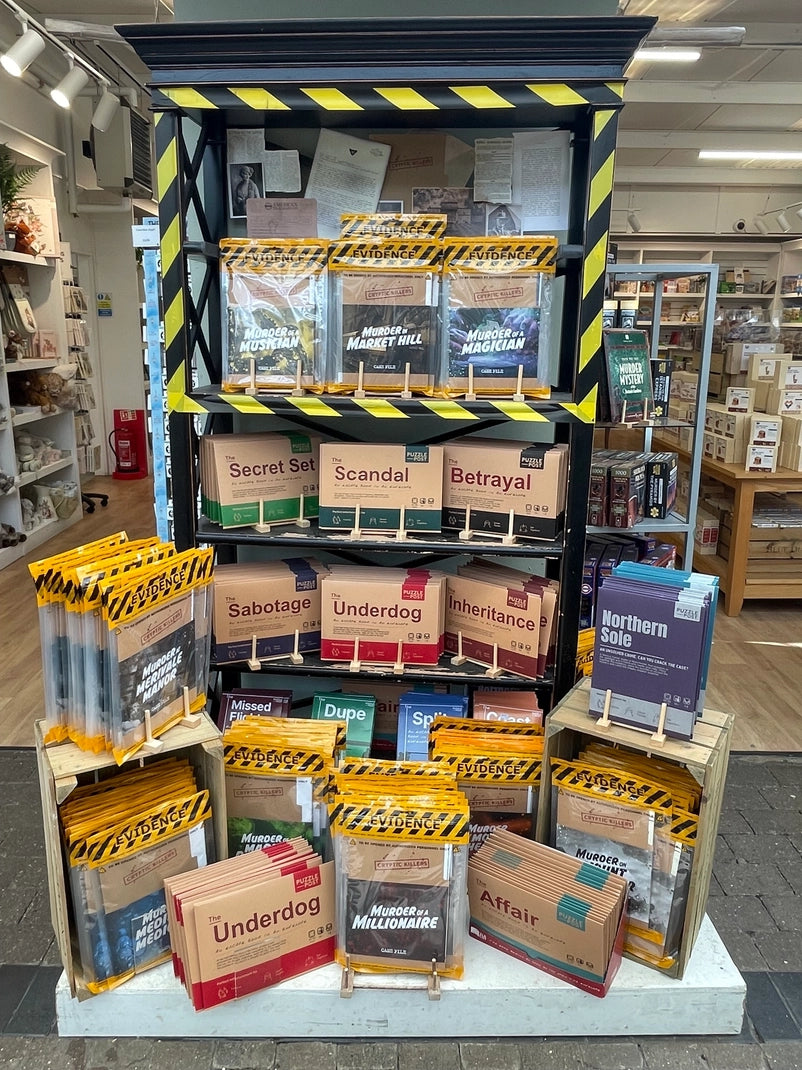 Puzzle Post Escape Room in an Envelope games displayed together in a retail setting