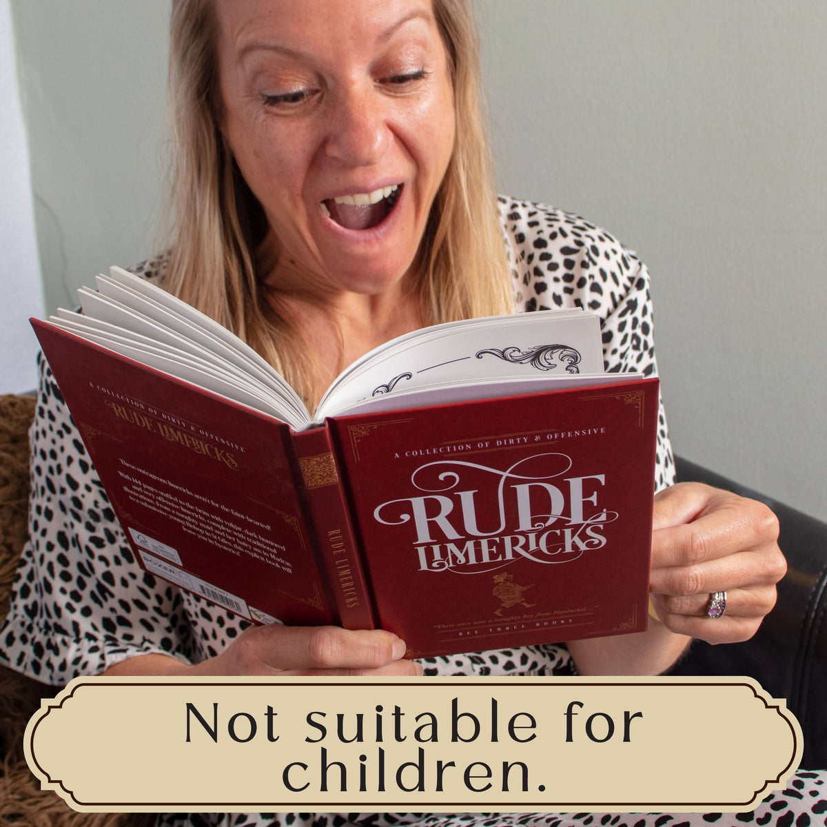 Rude Limericks book being read by a smiling woman, with a warning that the adult humour is not suitable for children.