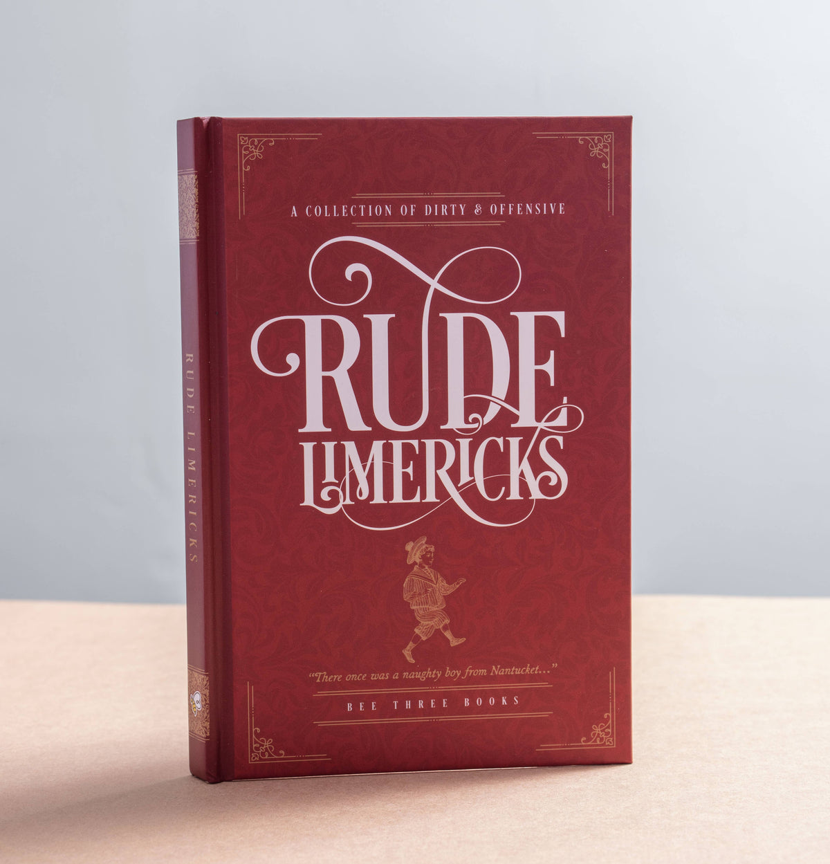 Rude Limericks hardback book with deep red cover, decorative gold detailing and vintage-style white lettering.